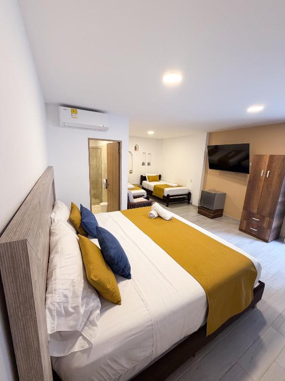 a bedroom with a large bed in a room at Hotel Casa Oliveros in Rivera