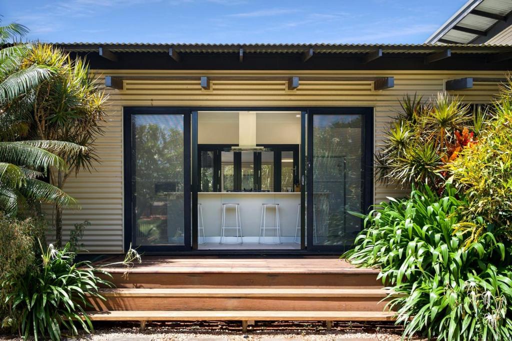 a house with sliding glass doors and a porch at Balu luxe in Broome