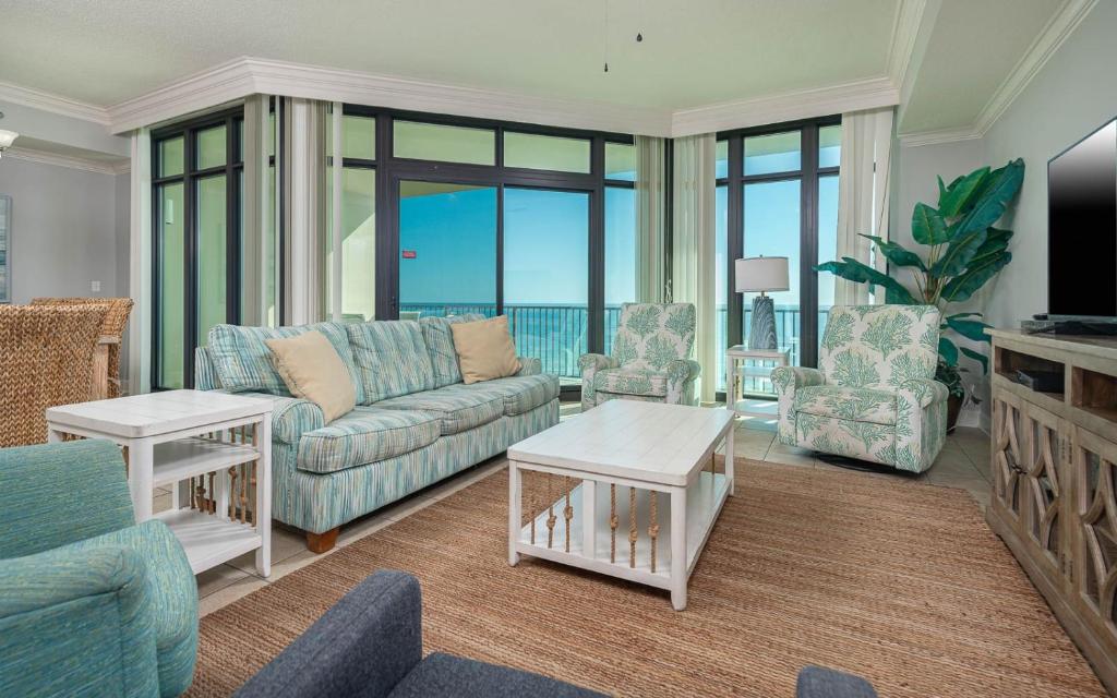 a living room with a couch and chairs at Phoenix West 708 in Orange Beach
