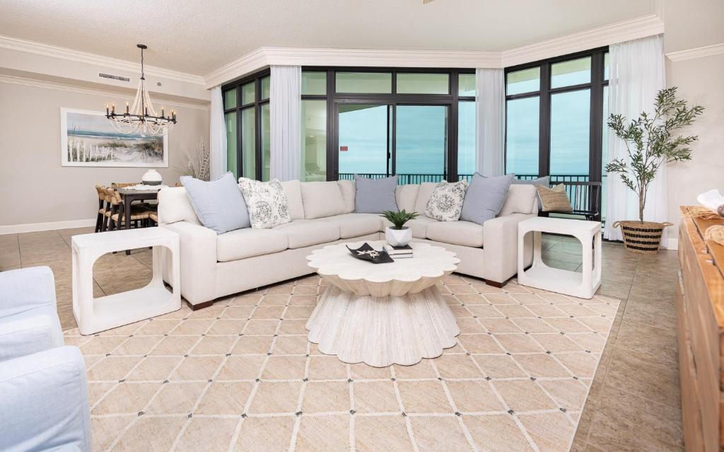 a living room with a couch and a table at Phoenix West 2008 in Orange Beach