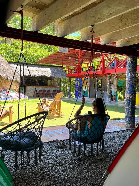 a woman sitting in a swing at a playground at Rocking J's in Puerto Viejo
