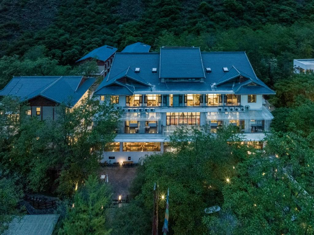 an aerial view of a large building with lights at Between Trees and Streams in Jiuzhaigou