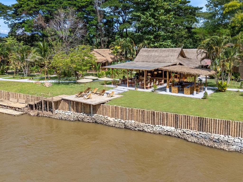 an image of a house next to a river at The Riverfront Reserve in Pai