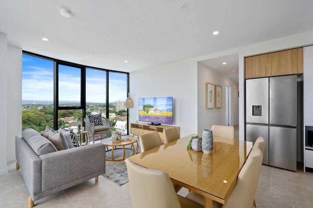 a dining room and living room with a table and chairs at The Gallery Broadbeach - Hosted by Gold Coast Luxury Resorts in Gold Coast