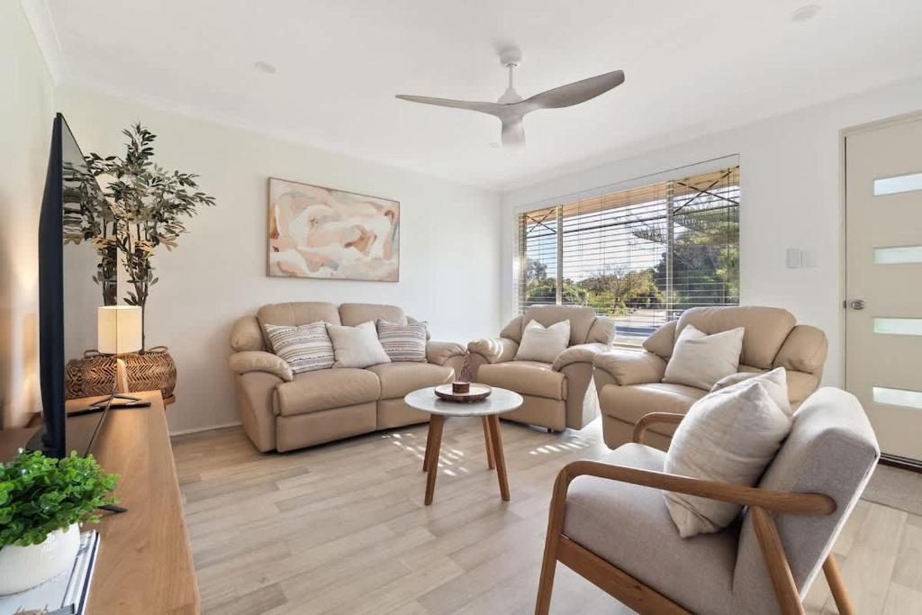 a living room with two couches and a tv at Luna Getaway in Quindalup