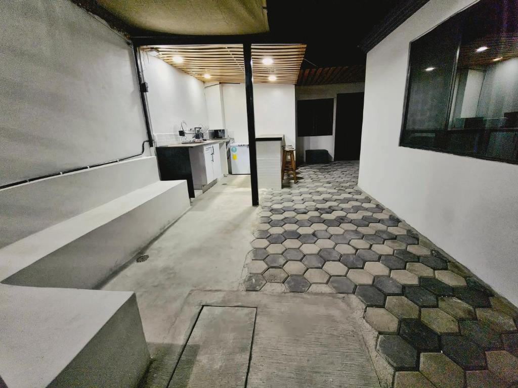 an empty room with a tile floor in a building at Casa Rayon Oaxaca in Oaxaca City