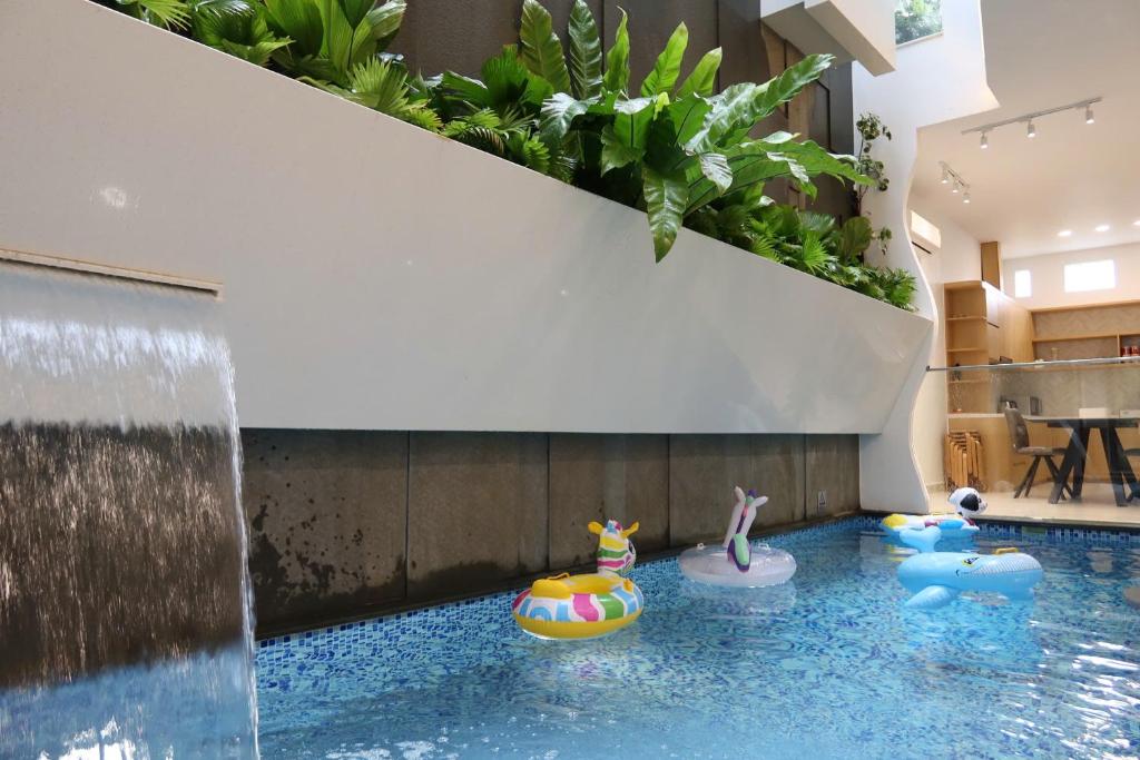 a indoor pool with a waterfall in a house at Lovela Villa Phan Thiết in Ấp Bình Hưng
