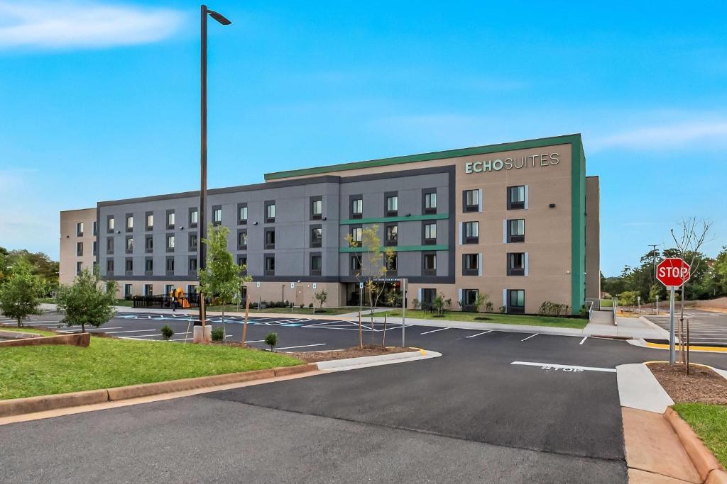 a large building on a street with a stop sign at ECHO Suites Extended Stay by Wyndham Sterling in Sterling