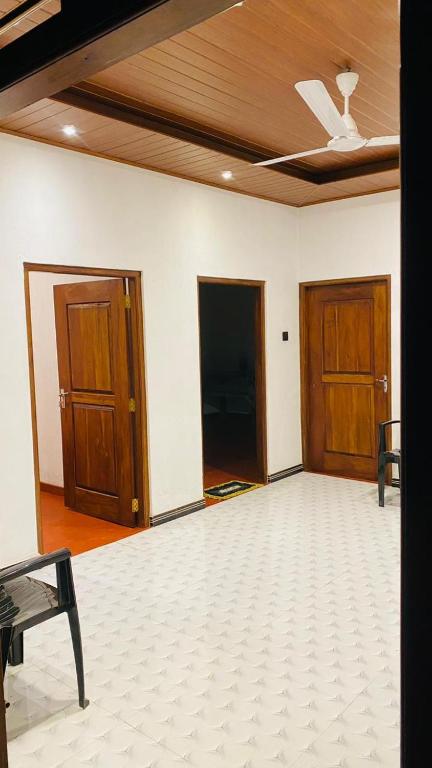 an empty room with two doors and a ceiling at Mangala gust house in Habaraduwa Central