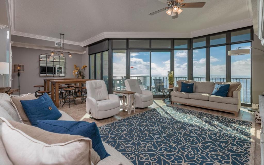 a living room with a couch and chairs and a table at Phoenix West 2203 in Orange Beach