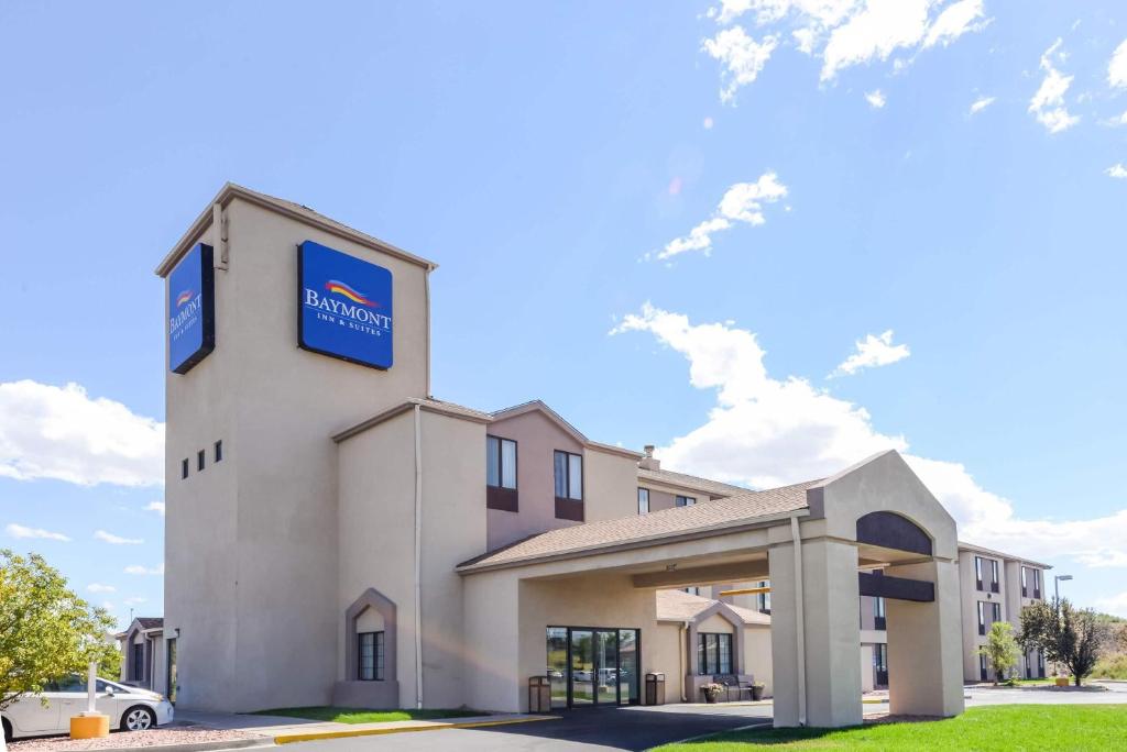 a hotel with a sign on the side of a building at Baymont by Wyndham Pueblo in Pueblo