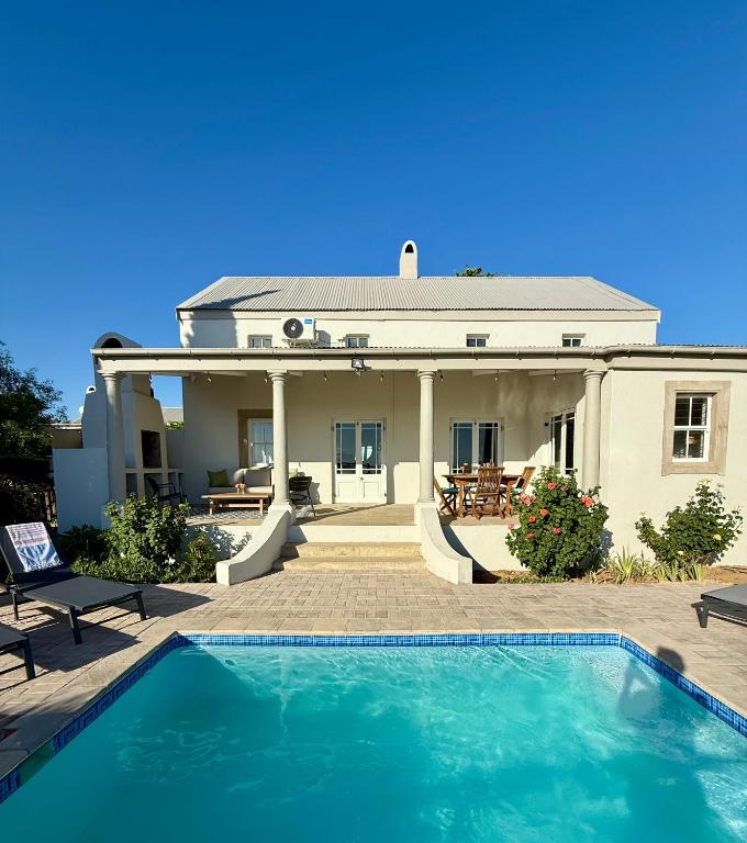 a house with a swimming pool in front of it at Grand View Cottages - 2 King Suites - Entire Cottage in Riebeek-Kasteel