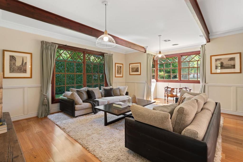 a living room with two couches and a table at Chestnut Tree Farm in Werai