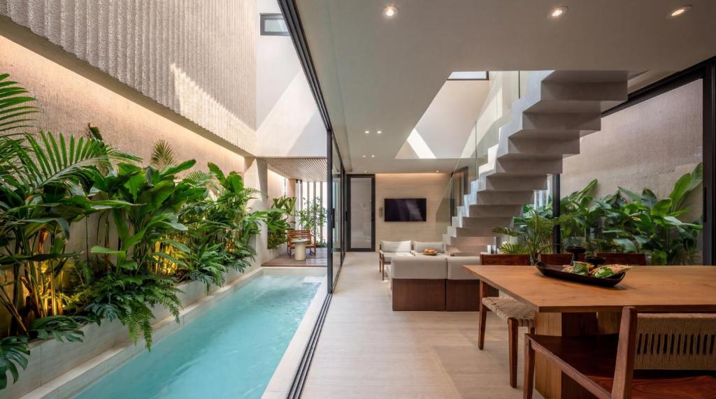 an indoor pool in a house with plants at POV Pool Villas in Ko Larn