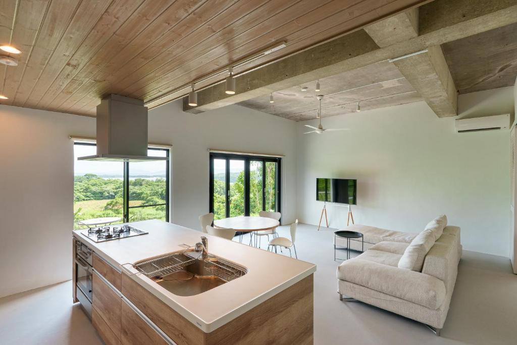 a kitchen and living room with a sink and a couch at Palm Hills in Ishigaki Island