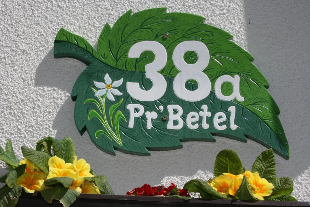 a sign on a building with a bird sign at Penzion Pr' Betel in Jesenice