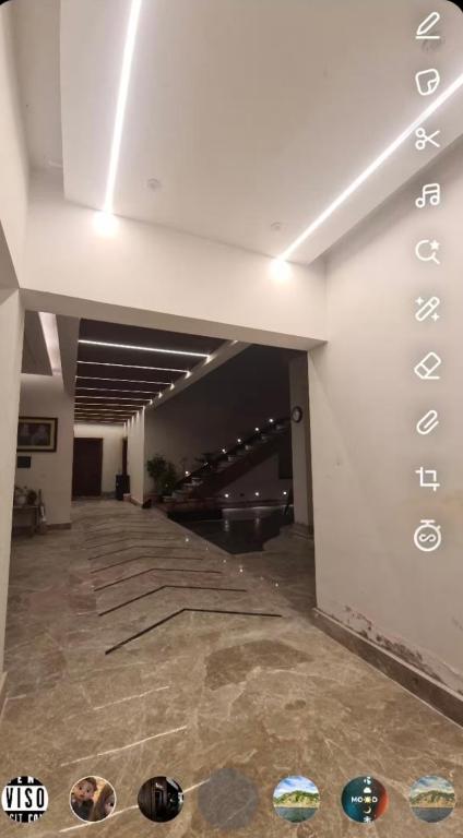 an empty room with a ceiling with lights on it at Happy Homes in Jammu