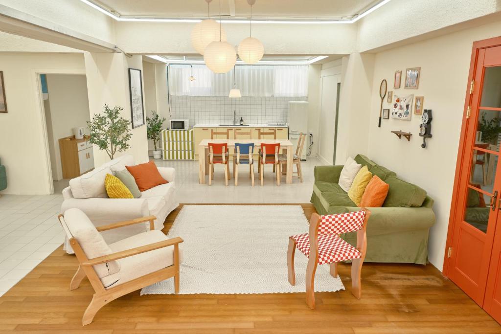 a living room with a couch and a table at The FLOW HOUSE in Suwon
