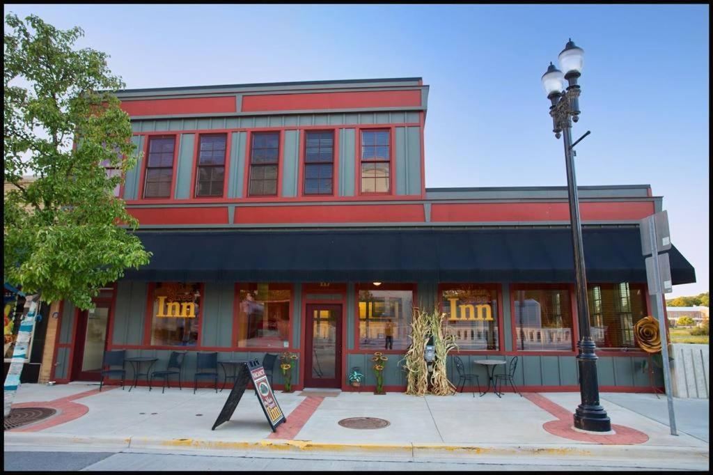 a red building with a street light in front of it at Main Street Inn in Lowell