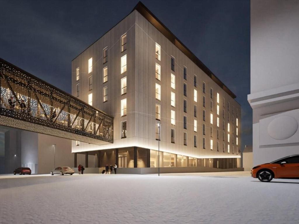 a building with a car parked in front of it at Santa's Hotel Noelle in Rovaniemi