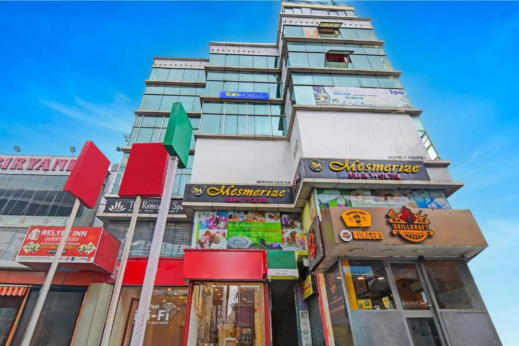 a tall building with signs on the side of it at FabHotel Relyef Inn in kolkata