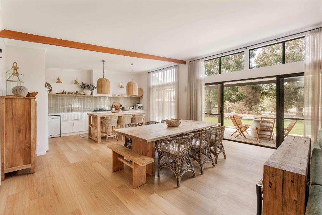 a large kitchen with a wooden table and chairs at Wilyabrup Waters Retreat in Wilyabrup