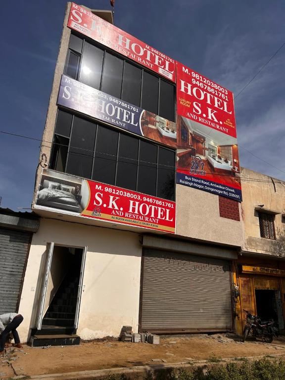 a building with signs on the side of it at SK Hotel Raisingh Nager in Rāisinghnagar