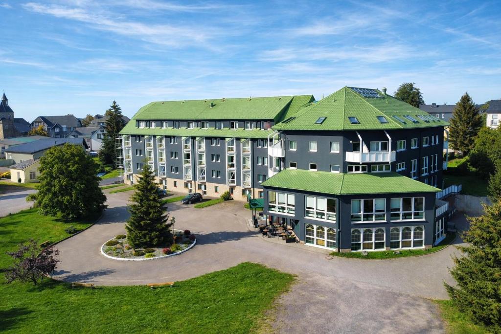 an aerial view of a large building with a green roof at Hotel Kammweg in Grossbreitenbach