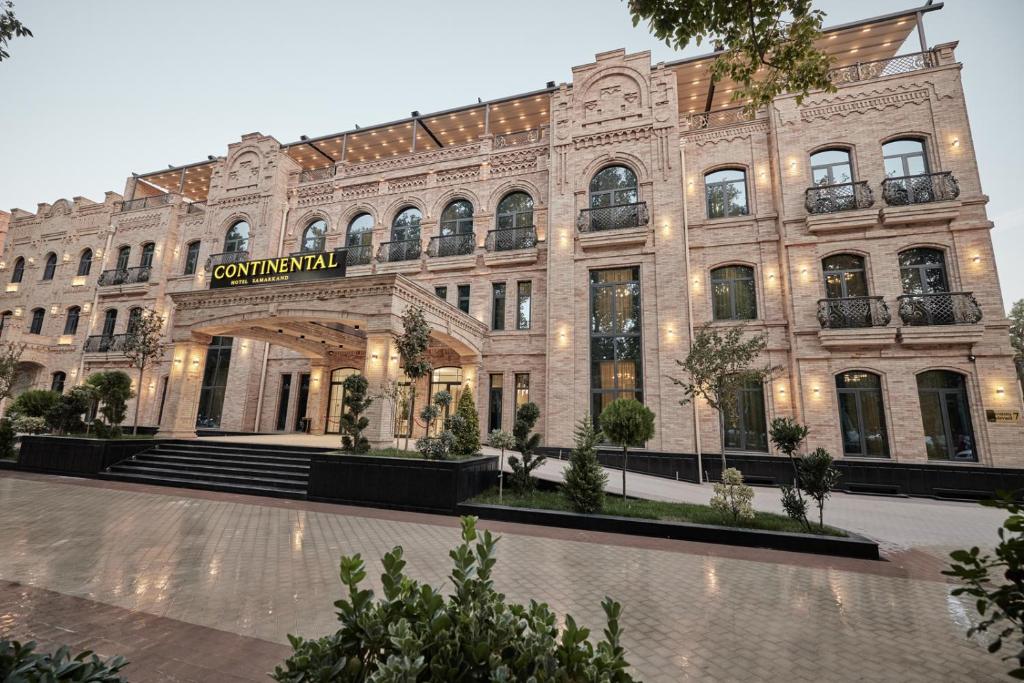 a large building with a sign on the front of it at Continental Hotel Samarkand in Samarkand