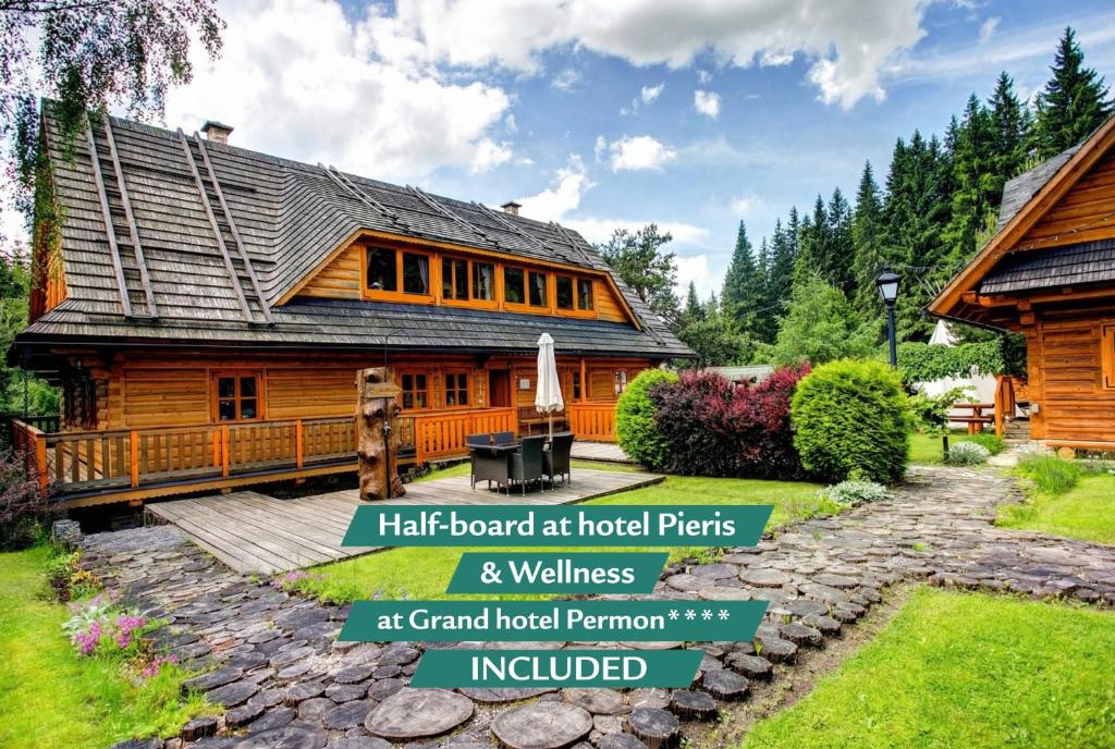 a log home with a porch and a yard at Pinius by Hotel Pieris in Pribylina