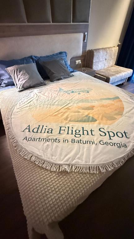 a bed with a sign that says alifa flight support agreements in batahuagon at Adlia Flight Spot in Batumi