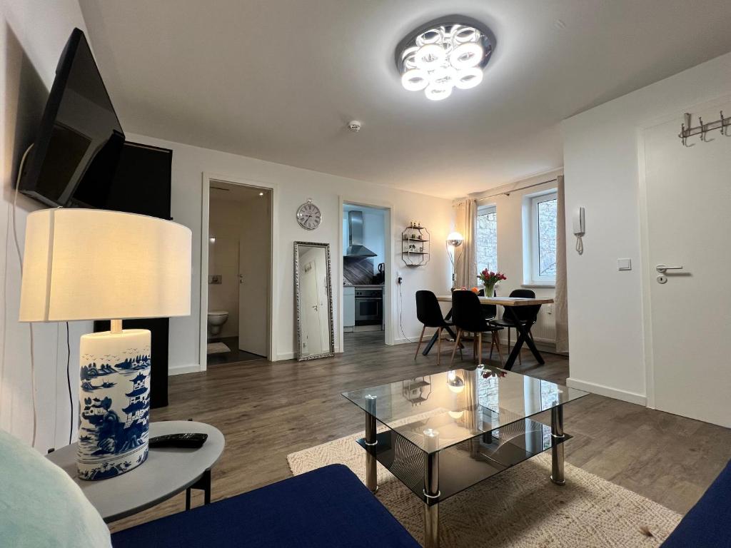 a living room with a glass coffee table and a living room at Apartment CentrumMitte Anger in Erfurt