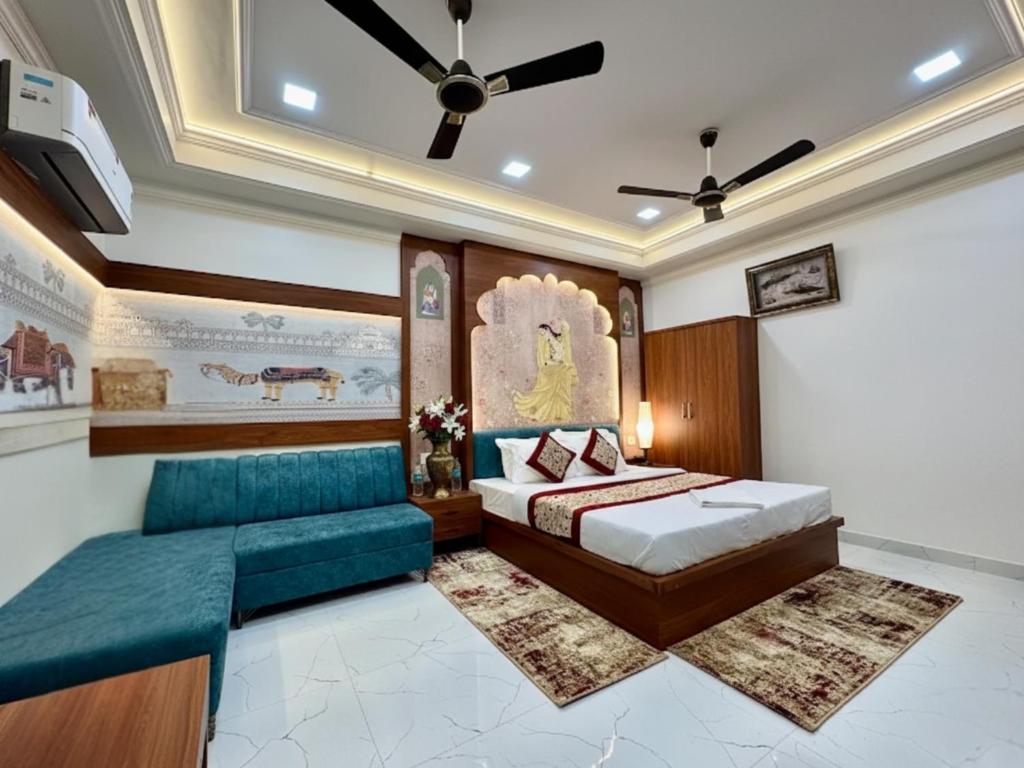a bedroom with a bed and a couch at SR Palace - Best Hotel in Vrindavan Near Prem Mandir and Iskcon Temple with Private Parking in Vrindāvan
