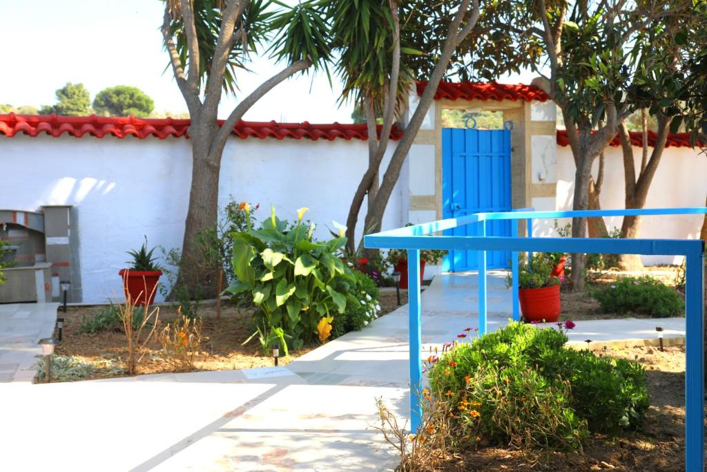 a blue table in front of a house with trees at X N Skiathos in Skiathos