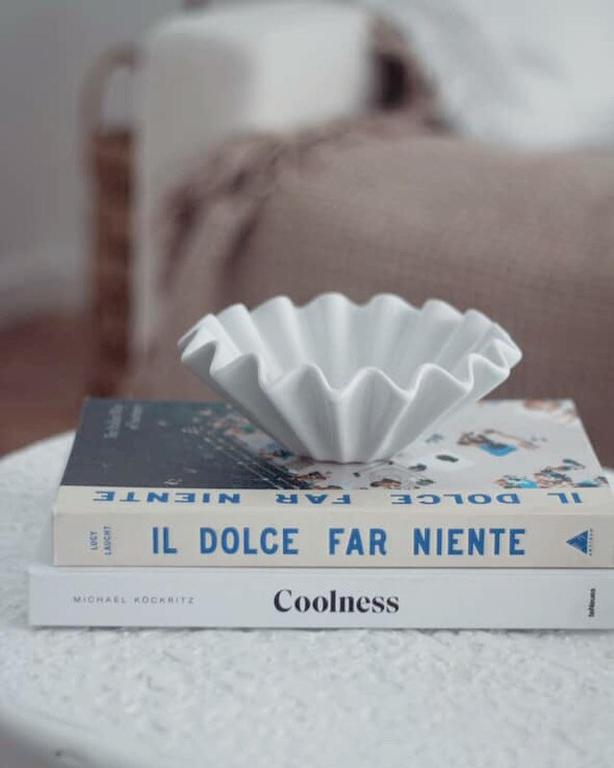 a book with a bowl on top of it on a table at Saltwater at Warilla Beach in Lake Illawarra