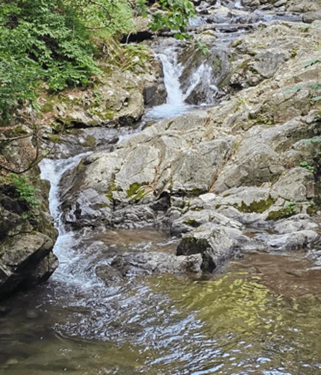 a stream of water flowing down a rocky river at Fortune Rising Sun Hill Pension in Pocheon
