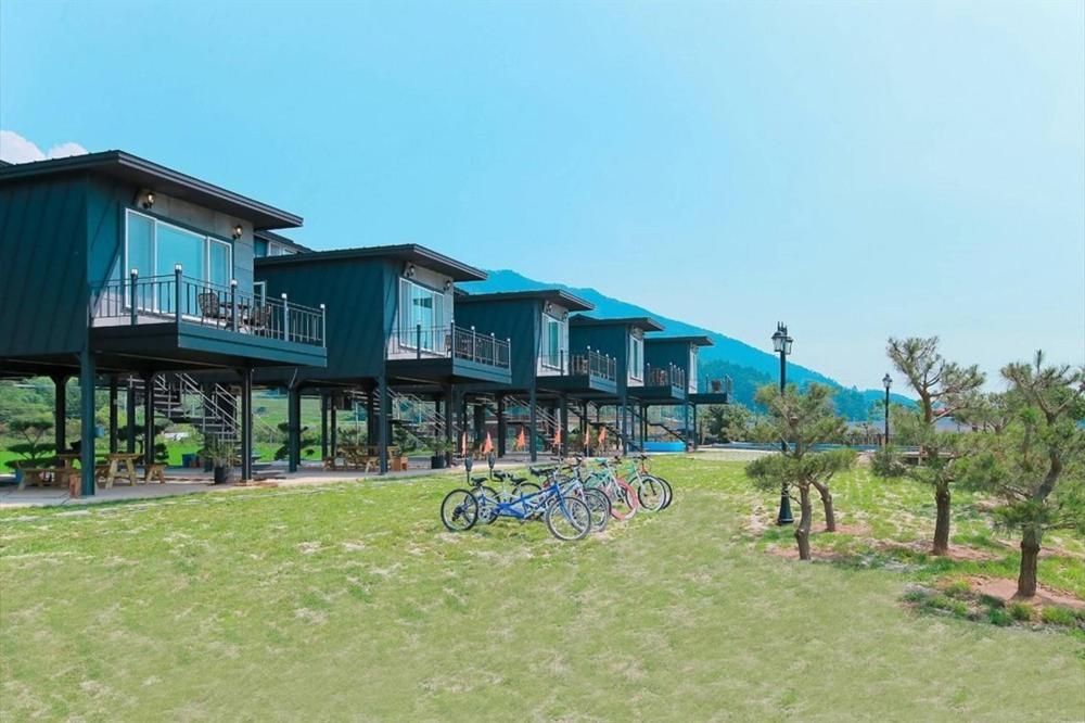 a row of houses with bikes parked in the grass at Jnj Village in Suncheon