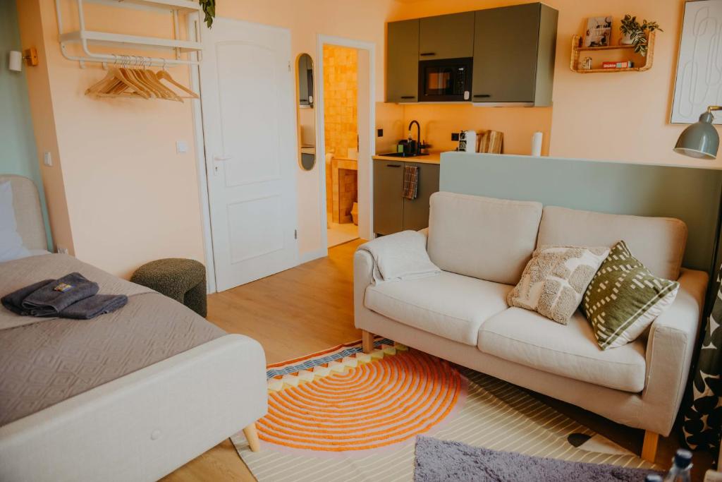 a living room with a couch and a kitchen at sleepArt cozy in Celle