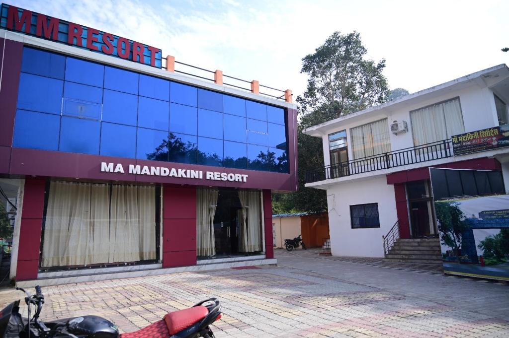 a motorcycle parked in front of a building at Maa Mandakini Resort & Hotel in Chitrakoot