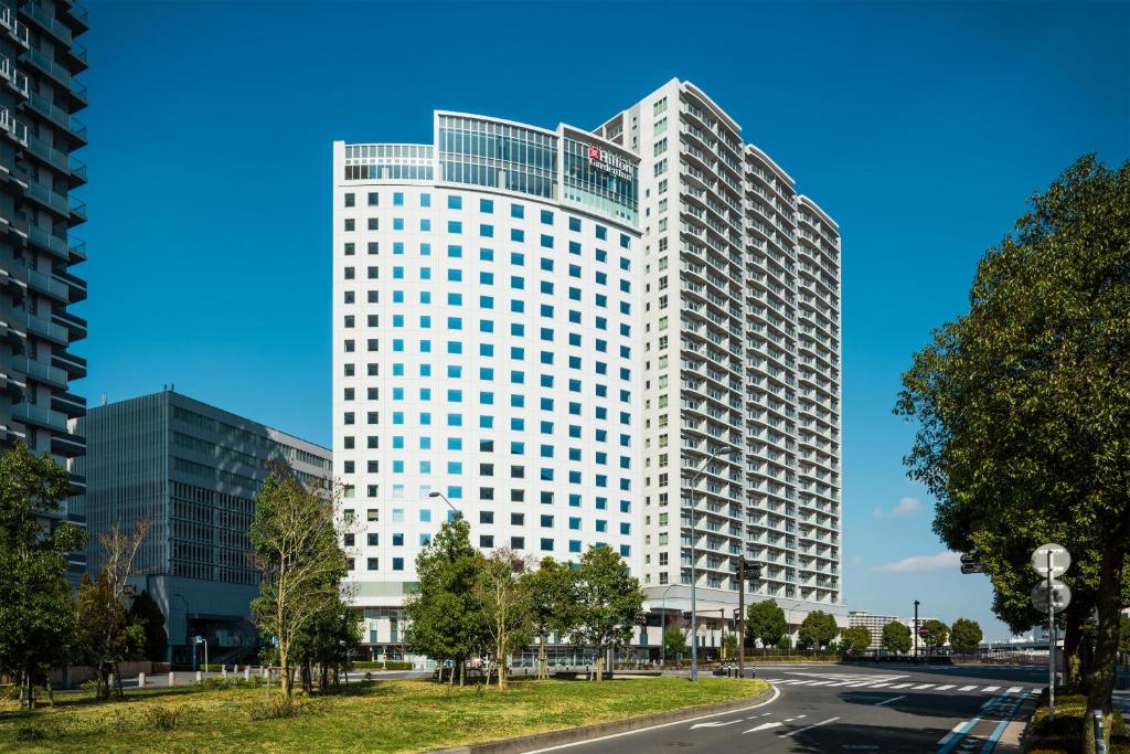 a tall white building with a road in front of it at Hilton Garden Inn Yokohama Minatomirai in Yokohama