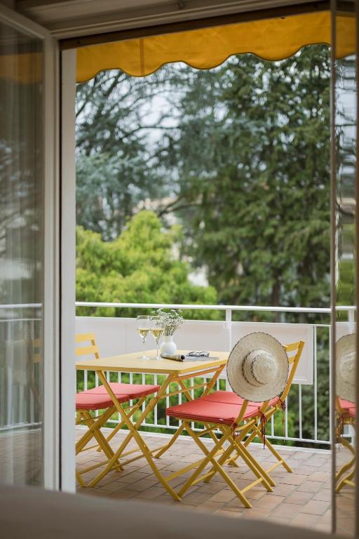 a table and two chairs on a balcony with a table at Villa Sabine in Merano