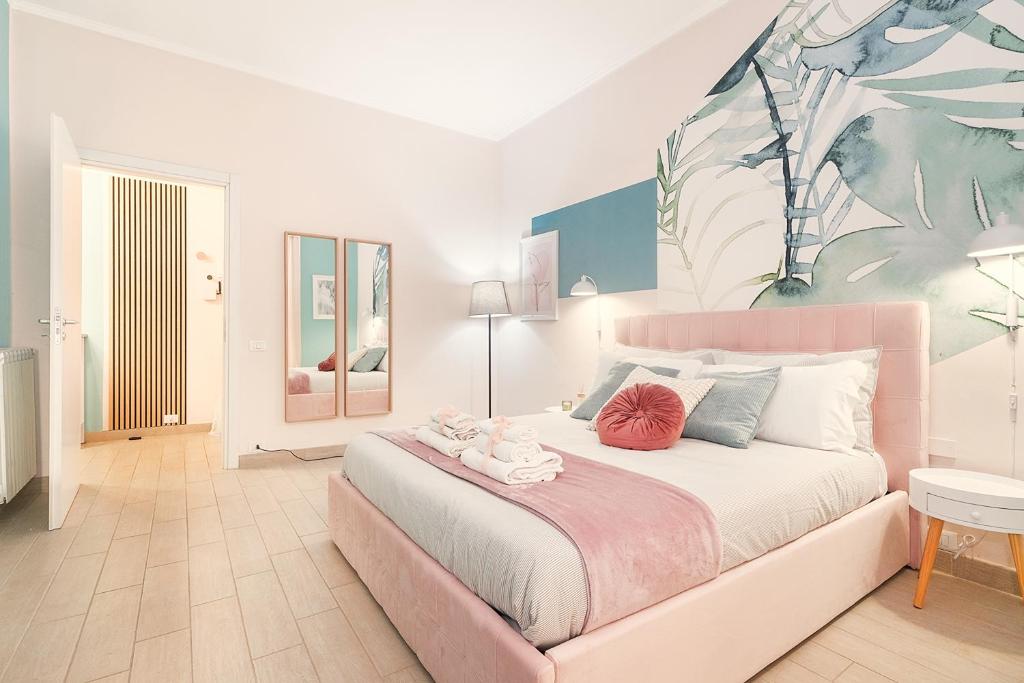 a bedroom with a large bed with a painting on the wall at Luxury Vatican Home - Private Garden in Rome