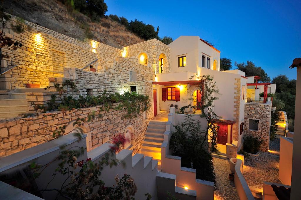 a house with stairs leading up to it at night at Stefanos Village Hotel in Plakias