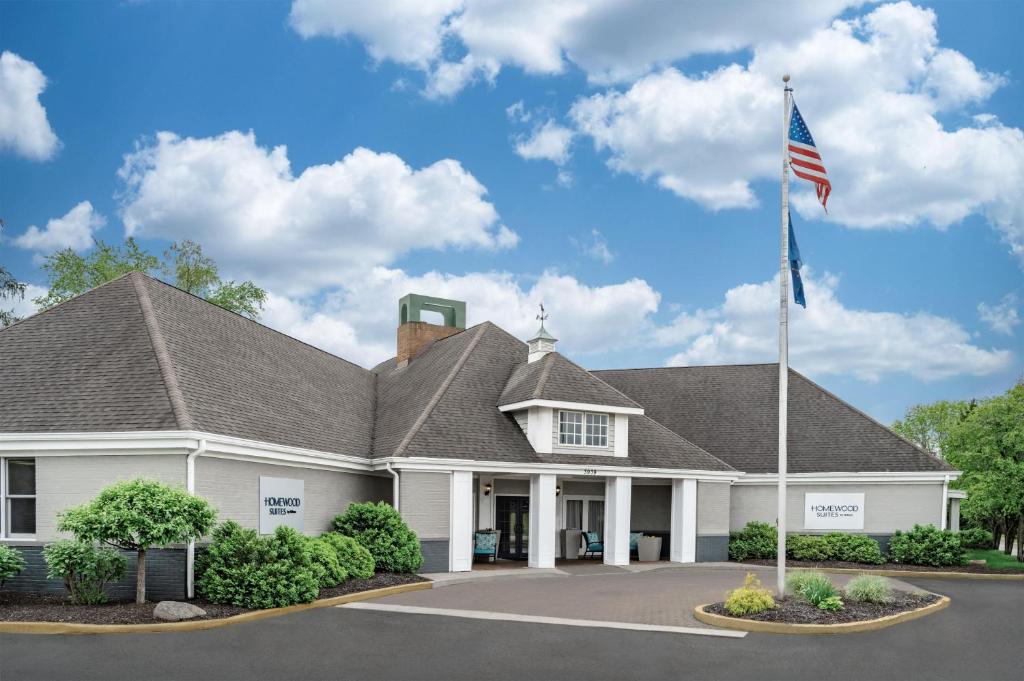 a building with an american flag in front of it at Homewood Suites Lafayette in Lafayette