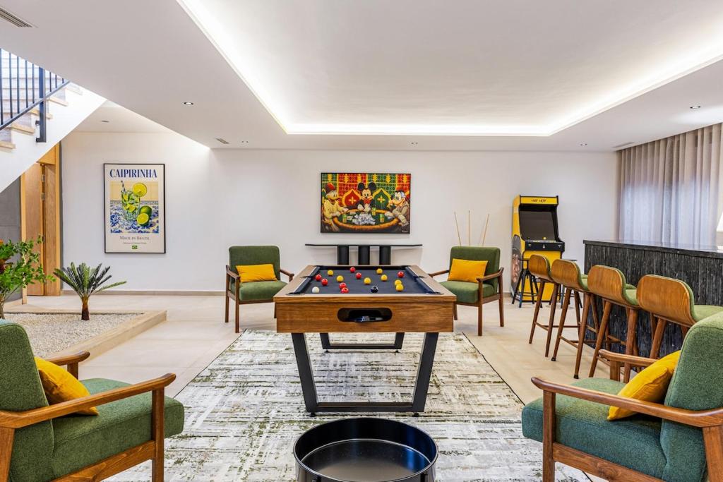a room with a pool table and chairs at Citrus Bloom Manor Marrakech in Oulad Mazoug