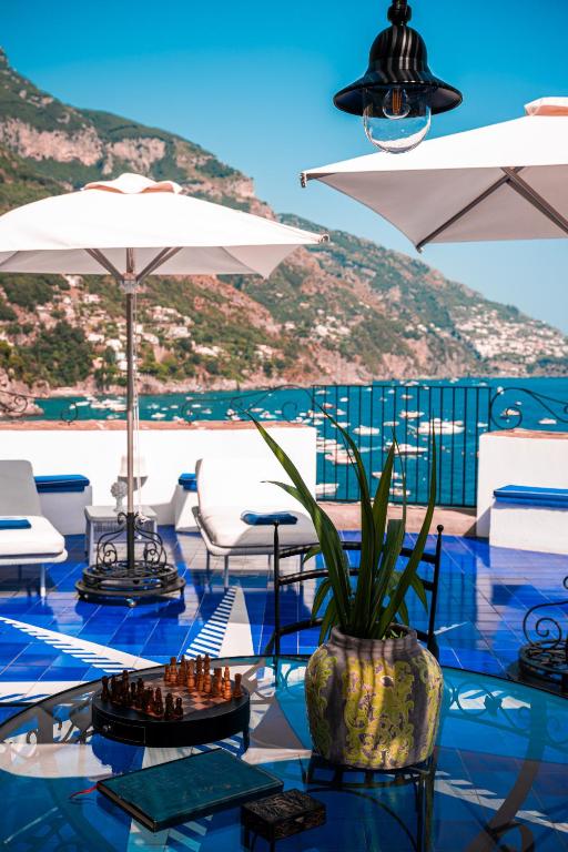 a pool with a chess board on a table at Villa Torre Trasita luxury suites in Positano