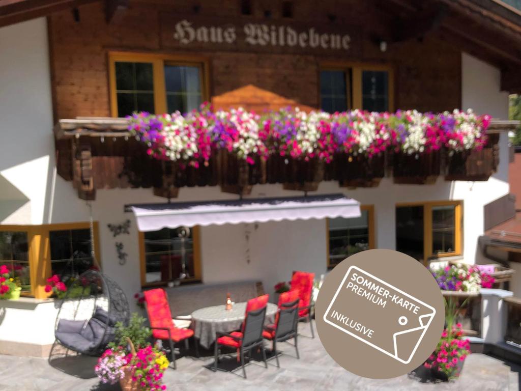 a restaurant with a table and chairs and flowers at Haus Wildebene in Sankt Anton am Arlberg