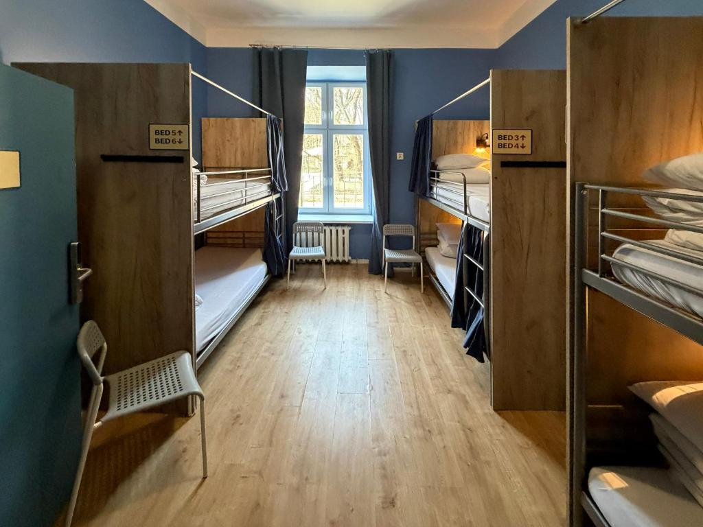 a room with many bunk beds and a room with aumbledore at WOW Hostel in Krakow