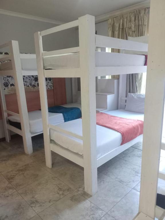 a couple of bunk beds in a room at Lodge & Backpackers at Star Legend Parow in Parow