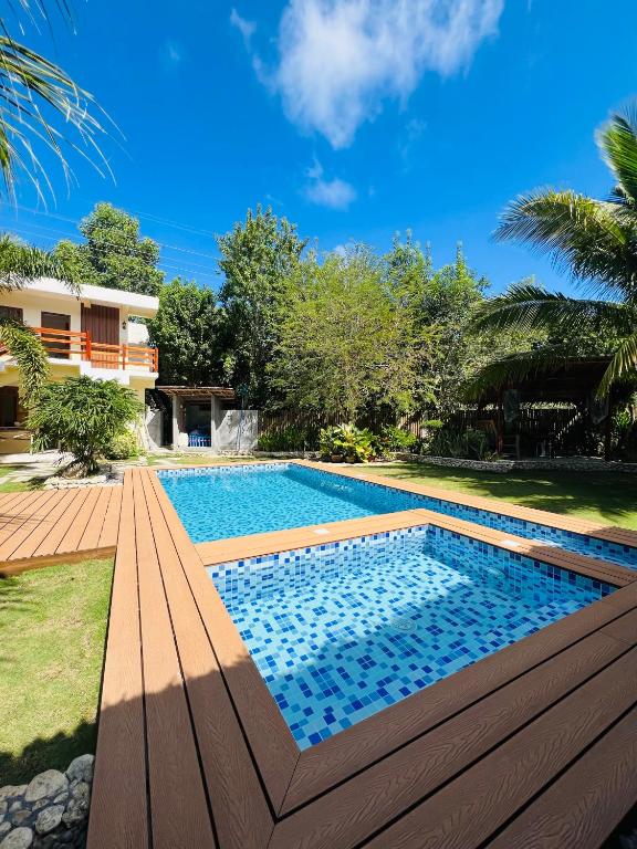 a swimming pool in a yard with a house at Sequor Palm Villa in Siquijor